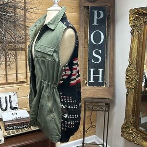 Army green vest with Aztec print at back